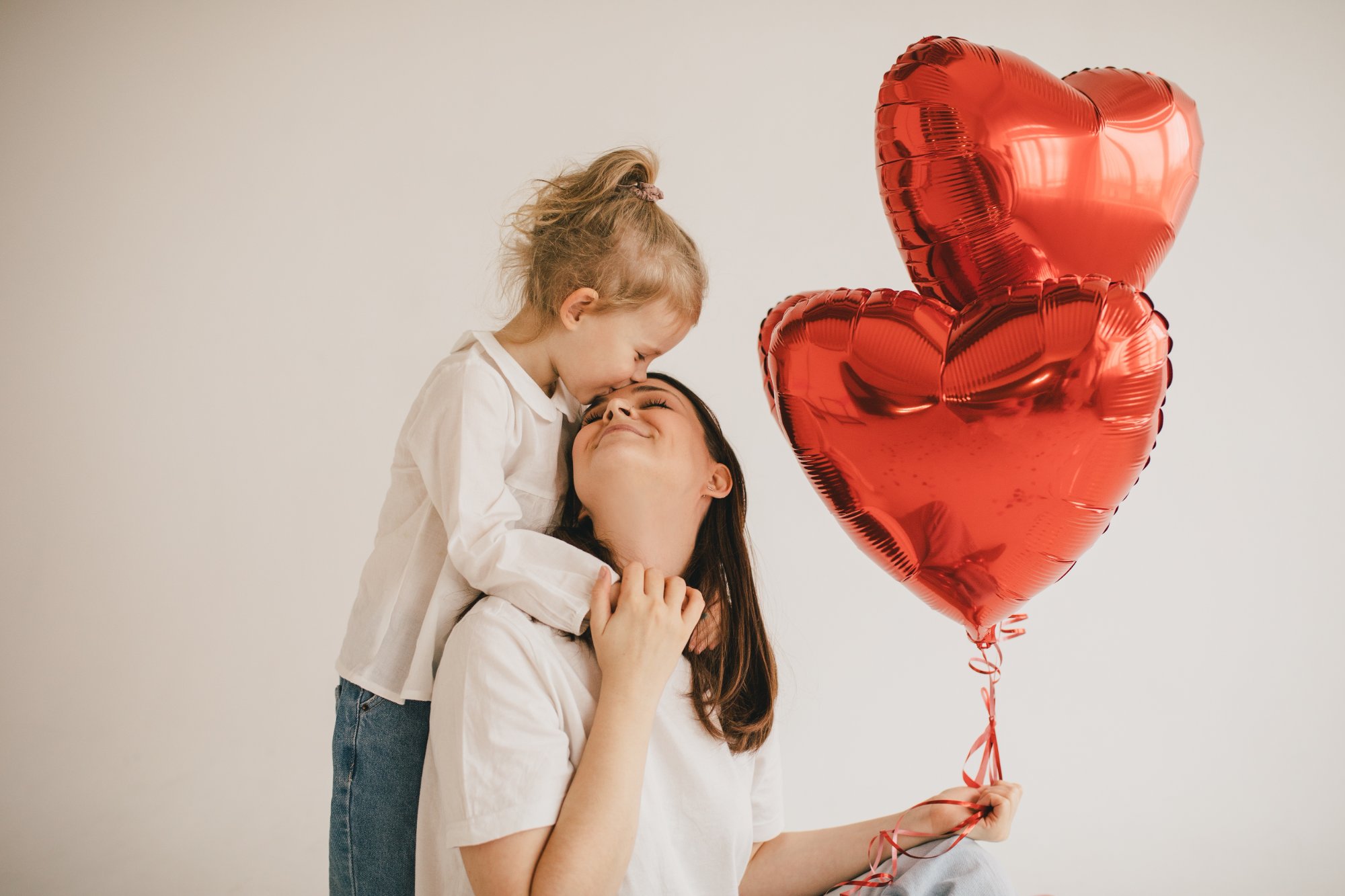 Mother's Day roses – mother and child with heart balloons